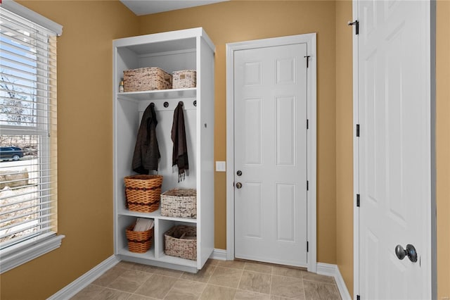 mudroom with light tile patterned flooring and baseboards