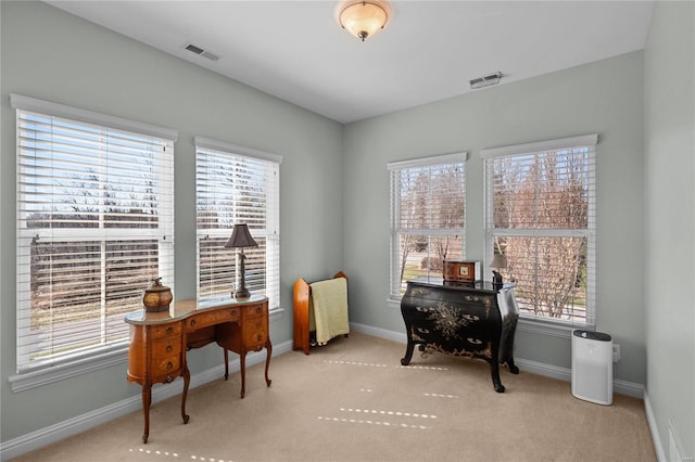 office area with baseboards, visible vents, a wealth of natural light, and carpet flooring