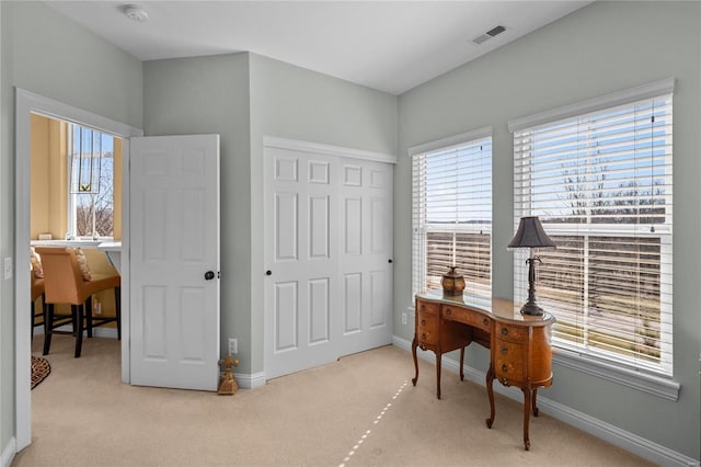 carpeted home office with visible vents and baseboards