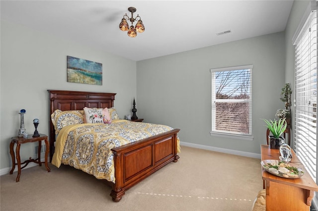 bedroom with visible vents, light carpet, baseboards, and an inviting chandelier