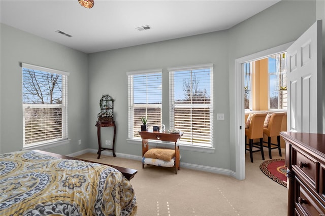 bedroom with baseboards, multiple windows, and visible vents