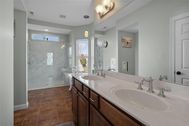 full bath featuring a shower with door, a sink, visible vents, and double vanity