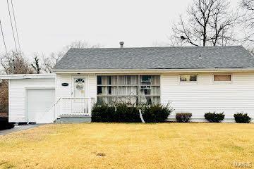 view of front of home with a garage and a front yard