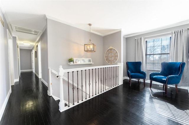 corridor featuring ornamental molding, wood-type flooring, an upstairs landing, and baseboards