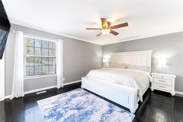 bedroom featuring hardwood / wood-style floors, visible vents, and baseboards