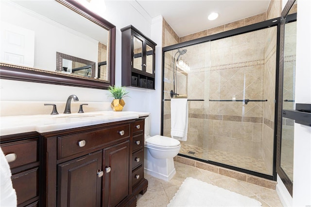 bathroom featuring crown molding, a shower stall, toilet, and vanity