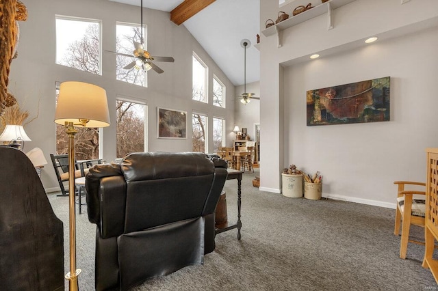 carpeted living area with a ceiling fan, baseboards, high vaulted ceiling, and beam ceiling