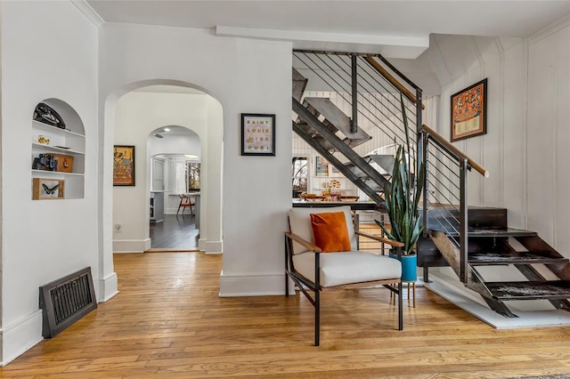 interior space featuring built in shelves and light hardwood / wood-style flooring