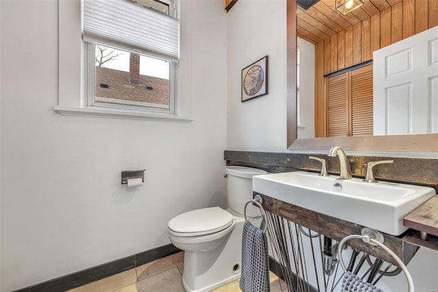 bathroom with wooden ceiling, tile patterned floors, and toilet