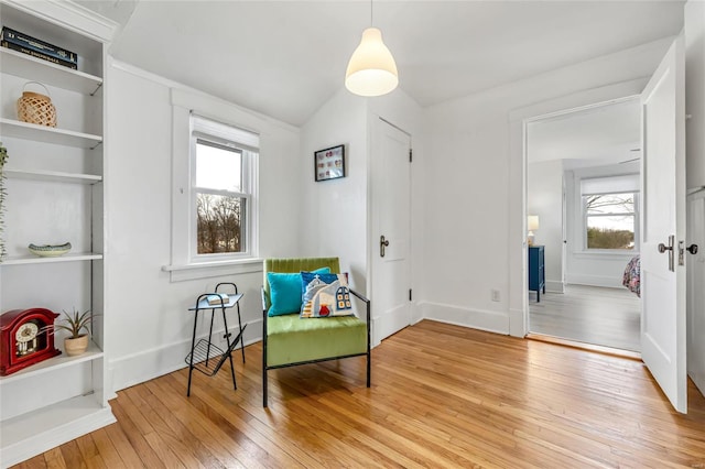 living area with hardwood / wood-style flooring and vaulted ceiling