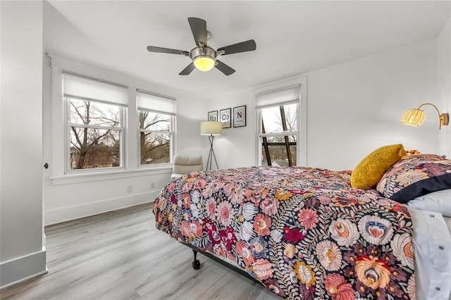 bedroom with ceiling fan and light hardwood / wood-style flooring