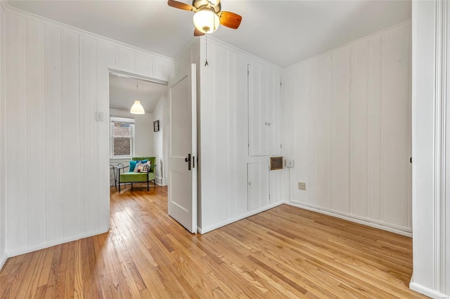 unfurnished room with ceiling fan and light wood-type flooring