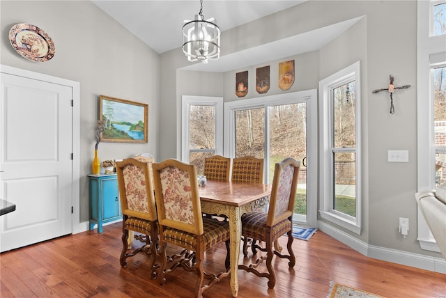 dining room featuring plenty of natural light, hardwood / wood-style floors, and a chandelier