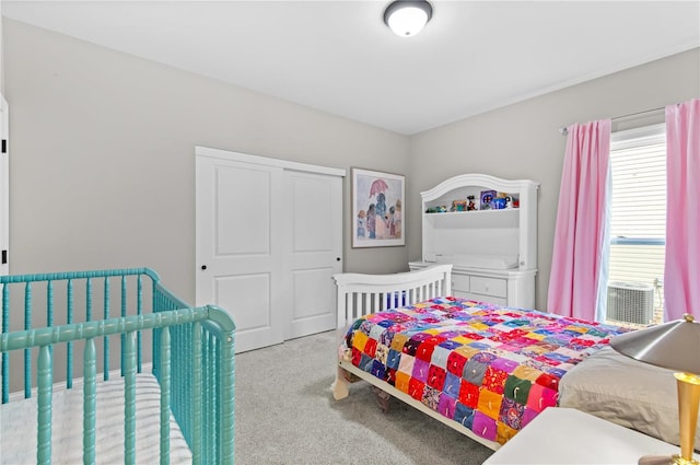 bedroom with light carpet and a closet