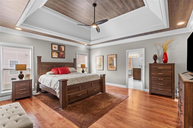 bedroom featuring light wood-type flooring and a tray ceiling