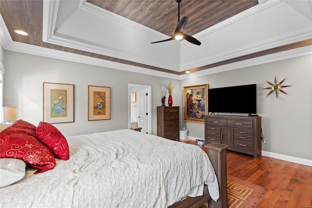 bedroom featuring crown molding, ceiling fan, dark hardwood / wood-style flooring, and a raised ceiling