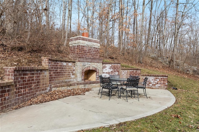 view of patio with an outdoor stone fireplace