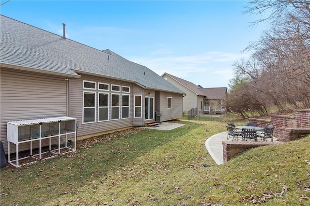 rear view of property with a patio area and a lawn