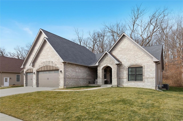 french provincial home with cooling unit, a garage, and a front yard