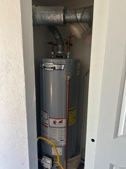 utility room featuring gas water heater