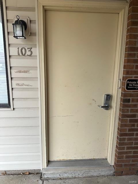 view of exterior entry with brick siding