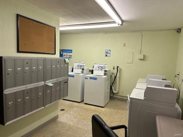 shared laundry area with mail area and washing machine and clothes dryer