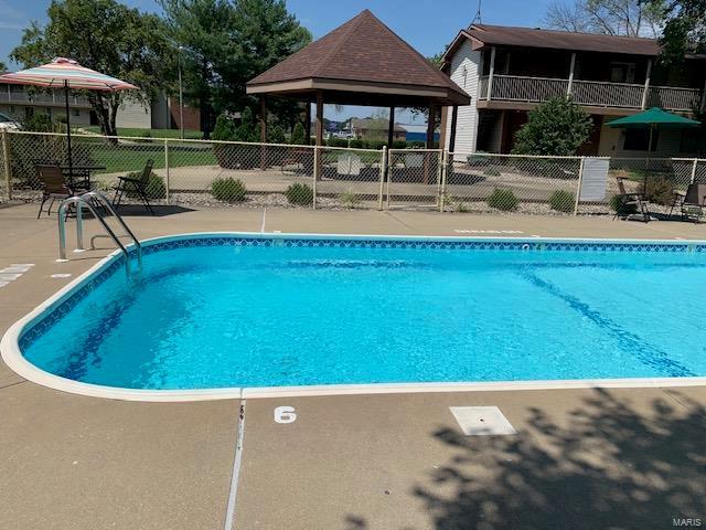 community pool featuring fence and a gazebo