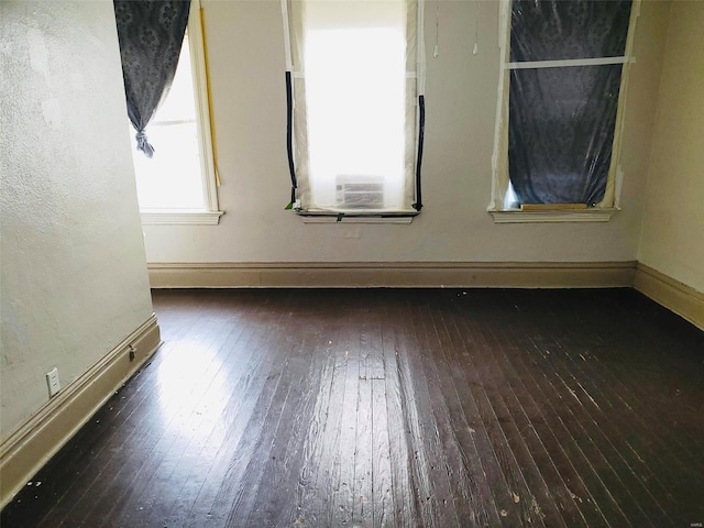 spare room featuring dark hardwood / wood-style flooring