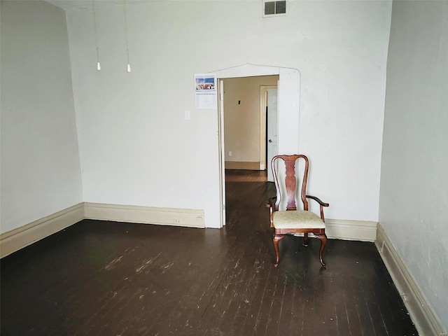 sitting room with dark wood-type flooring