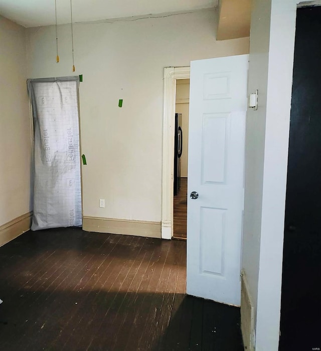 spare room with dark hardwood / wood-style flooring