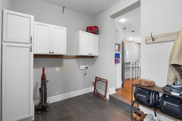 laundry room with baseboards