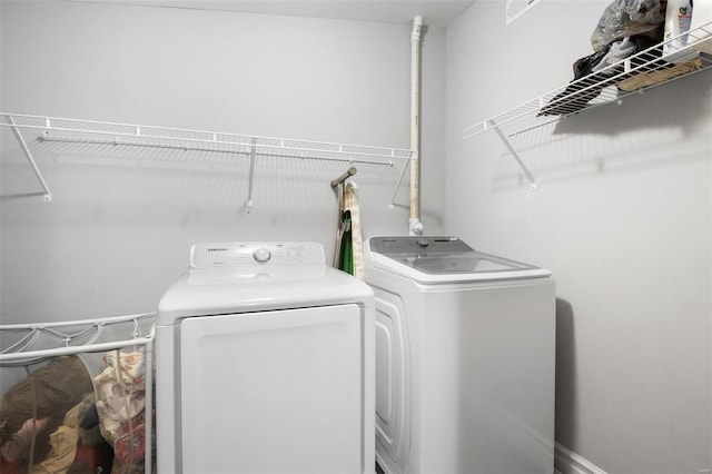 clothes washing area featuring laundry area and washing machine and clothes dryer