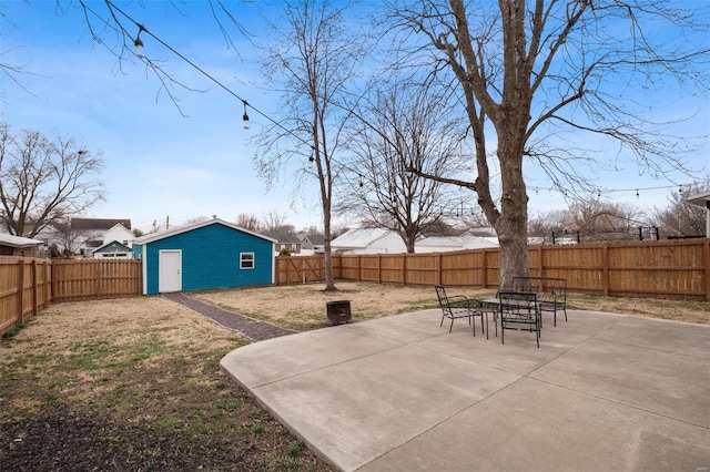 view of patio / terrace featuring a fenced backyard and an outbuilding