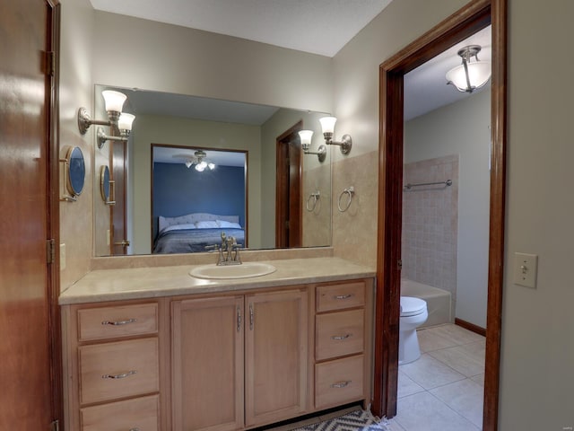 bathroom with tile patterned floors, toilet, vanity, and a tub