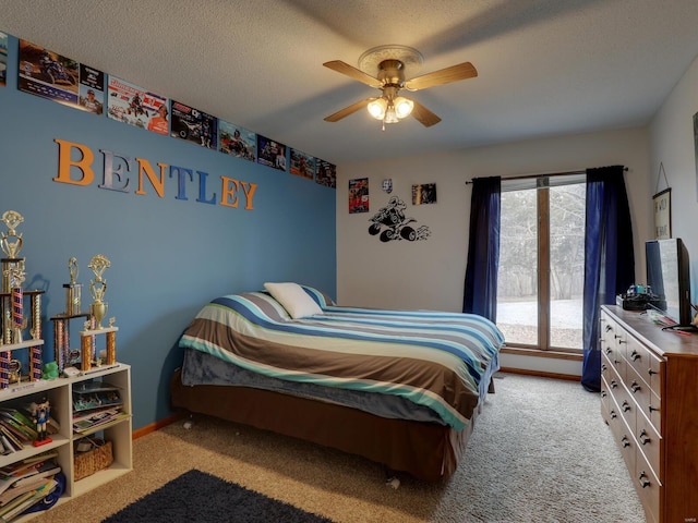 carpeted bedroom featuring ceiling fan and a textured ceiling