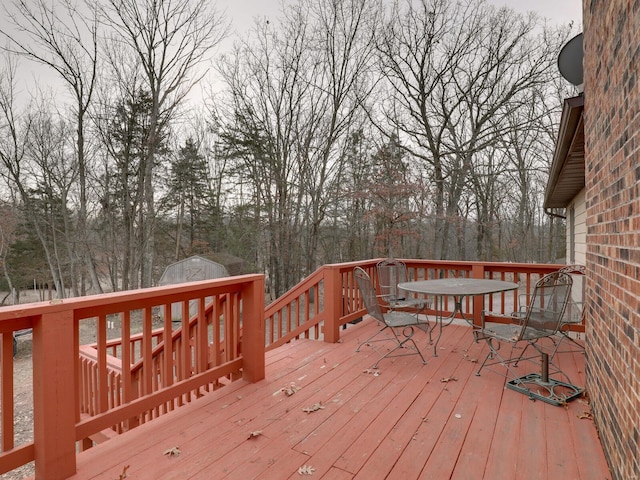 wooden deck featuring a storage shed