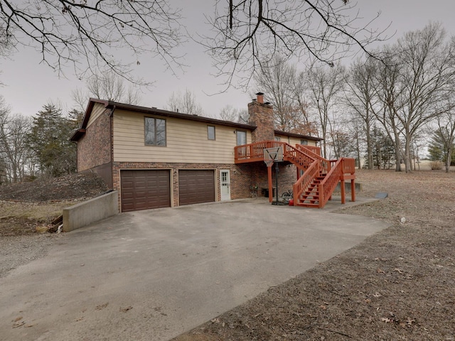 exterior space featuring a wooden deck and a garage