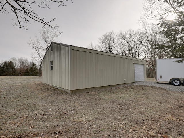 view of side of home featuring a garage and an outdoor structure