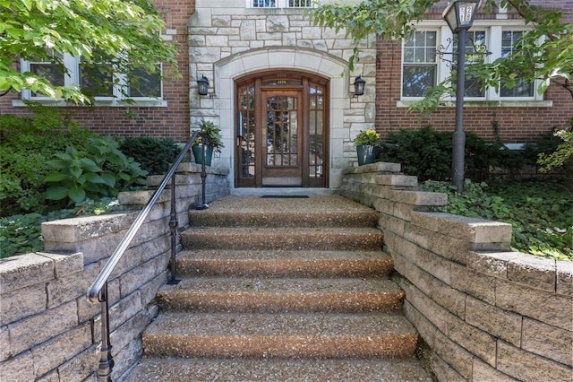 property entrance with stone siding and brick siding