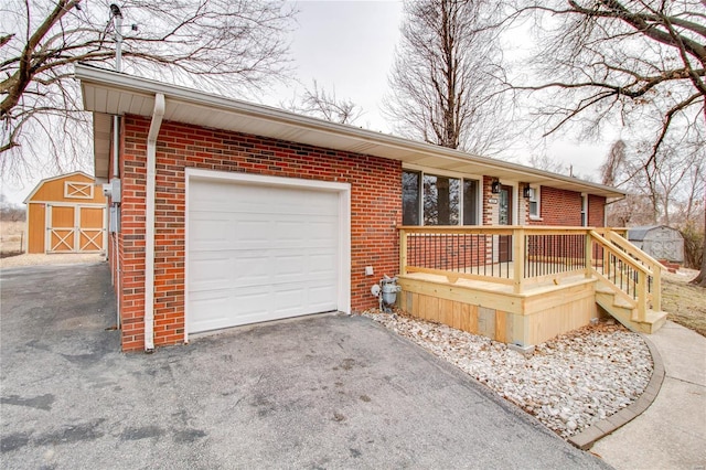 single story home with a porch, a garage, and a shed