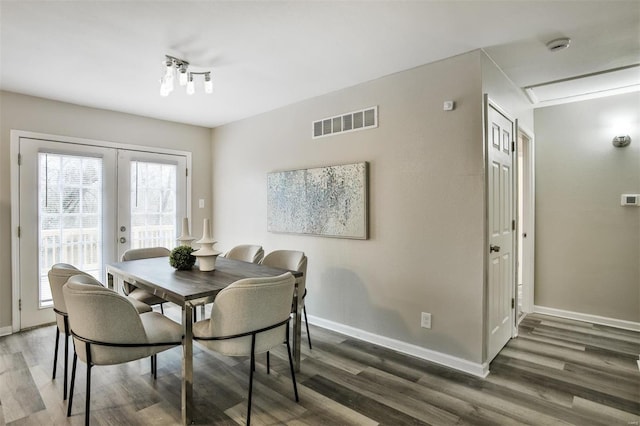 dining space with dark hardwood / wood-style flooring and french doors