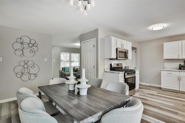 dining space featuring light wood-type flooring