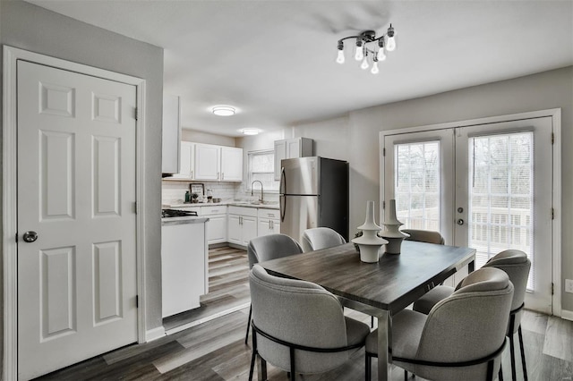 dining area featuring dark hardwood / wood-style floors, sink, and french doors