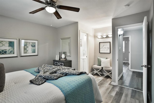 bedroom with hardwood / wood-style flooring, ceiling fan, and ensuite bath