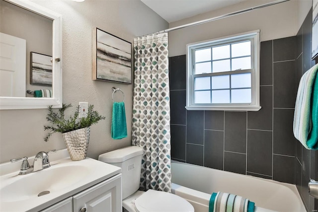 full bathroom with vanity, shower / tub combo, and toilet