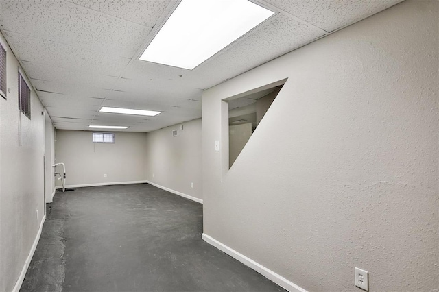 basement featuring a paneled ceiling