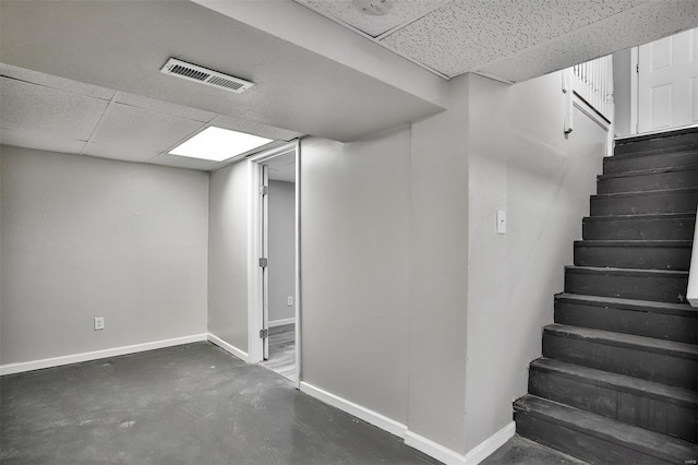 basement featuring a drop ceiling