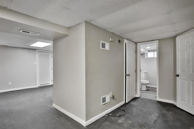 hall featuring a paneled ceiling