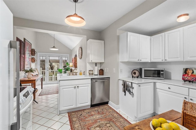 kitchen with decorative light fixtures, light tile patterned floors, appliances with stainless steel finishes, kitchen peninsula, and white cabinets