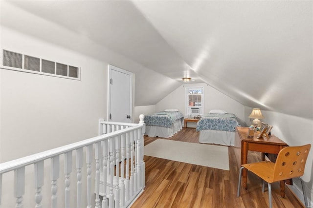 bedroom with hardwood / wood-style flooring and vaulted ceiling